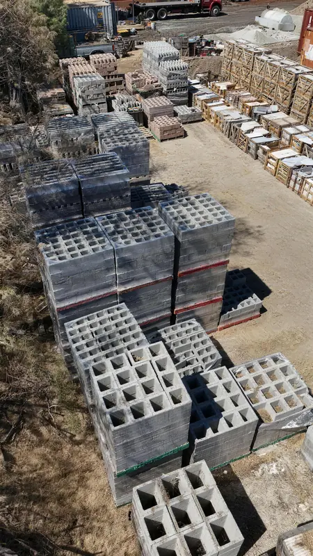Standard CMU blocks neatly stacked on pallets, a staple material for walls, foundations, and retaining structures.