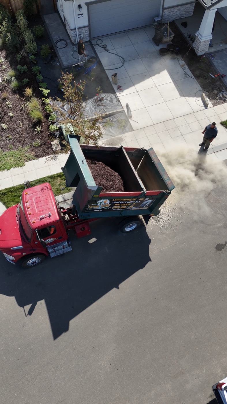 Material being dumped from a Golden Valley Materials truck, raising dust