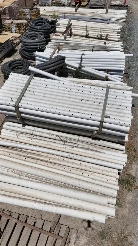 Irrigation and drainage supplies including PVC pipes, perforated drain lines, and corrugated tubing in a range of sizes.