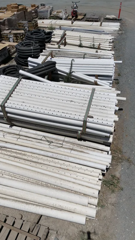 A closer look at our irrigation and drainage stock — solid and perforated PVC alongside coiled corrugated pipe.