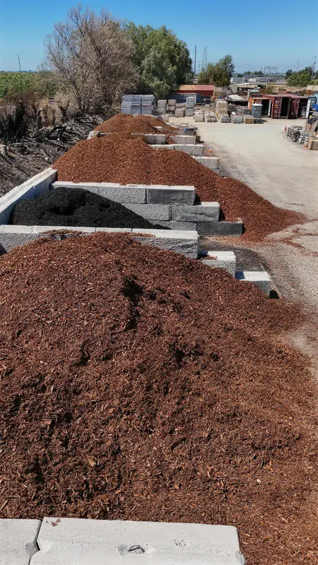 Bark mulch varieties displayed in bulk bins, showing the natural texture and rich colors available for garden and landscape applications.