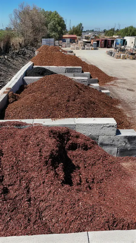 A selection of colored and natural mulch options, ranging from deep red to natural brown, to suit any design preference.