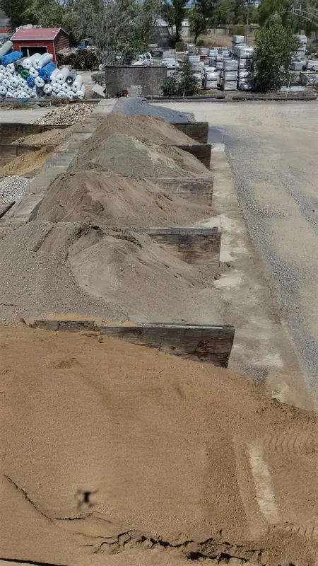 Construction and landscaping sand available in various grades and colors, stored in organized bins for convenient access.
