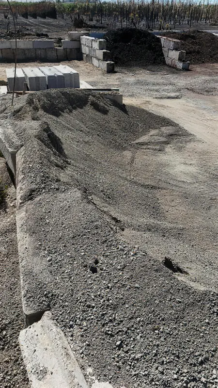 Bulk gray crushed rock in one of our yard bins, ready for pickup or delivery.